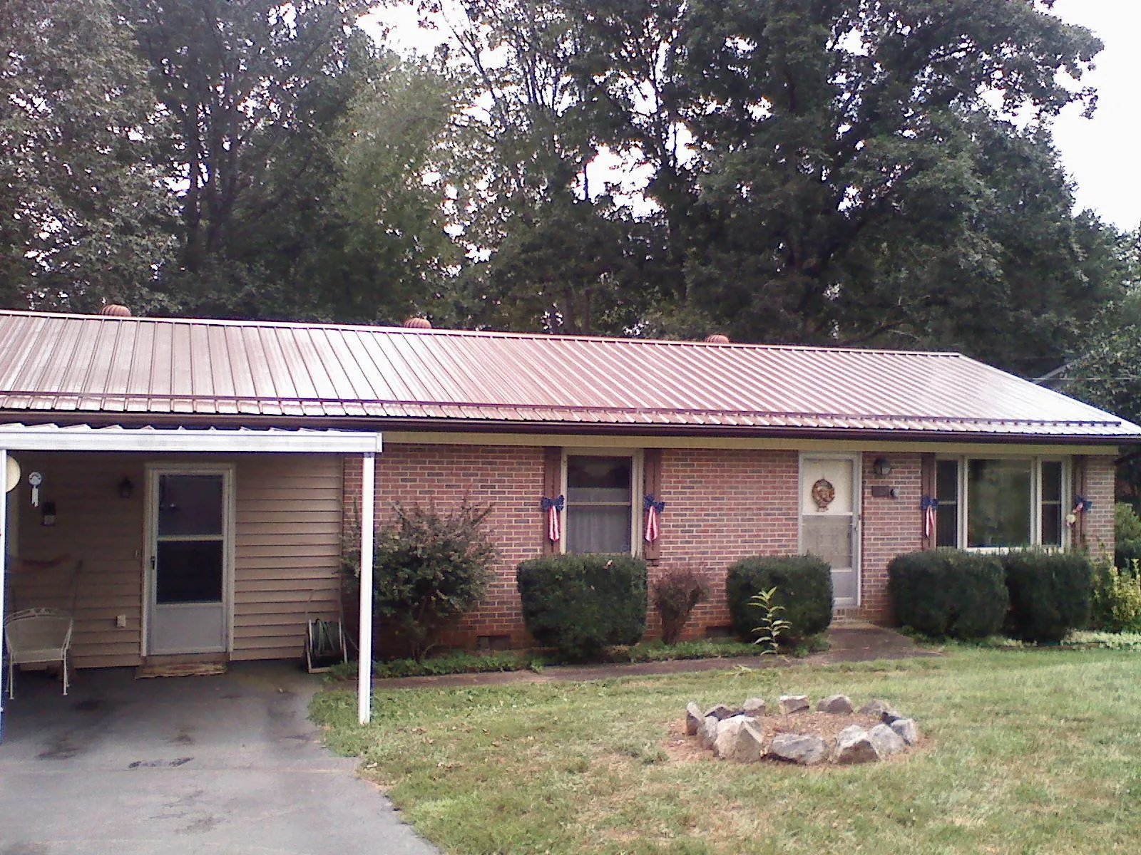 Bronze metal roof and carport on a brick ranch home — Roof Repair work by our crew in Holtwood