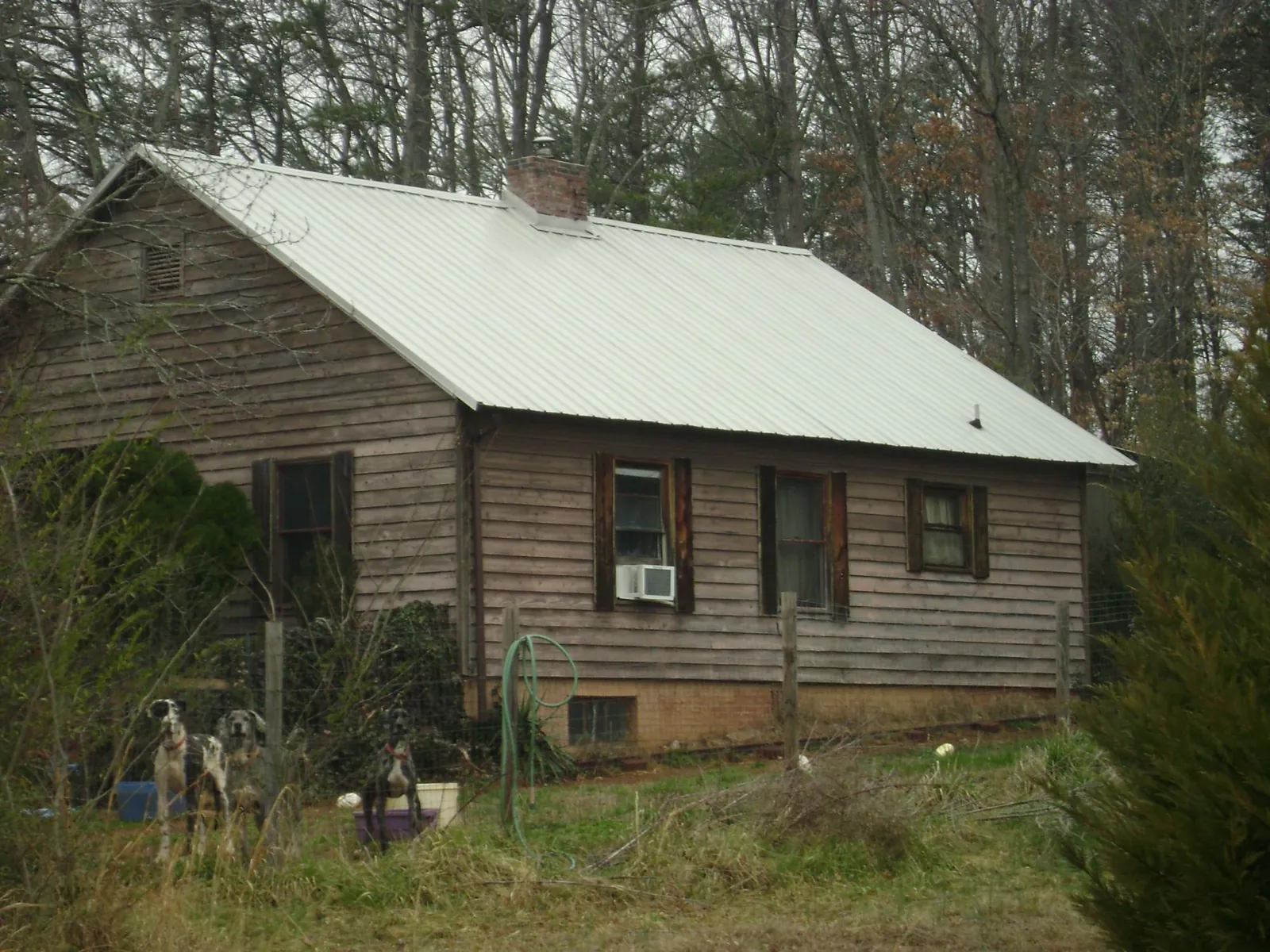 White metal roof on an old wood sided farmhouse, from a Metal Roof Installation job in Holtwood